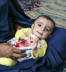 A child eats Plumpy'Nut, a peanut paste used to treat malnutrition.