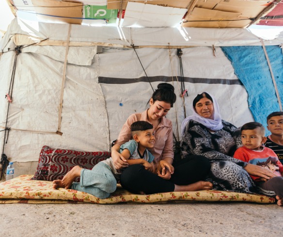 A family sits in their tent in Chamisku, a camp in northern Iraq.